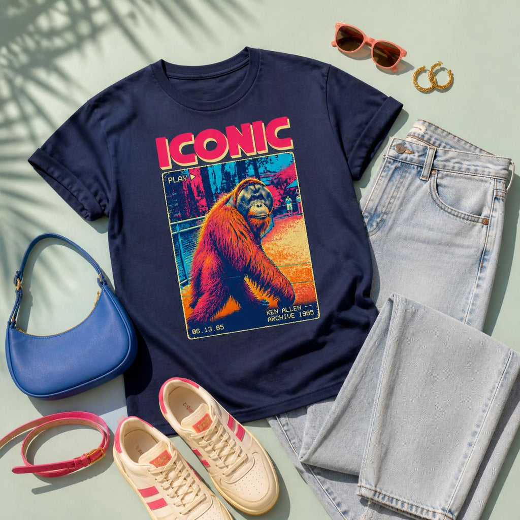 Navy Ken Allen Iconic graphic tee styled with light-wash jeans, cream sneakers, a pink belt, a blue bag and retro accessories